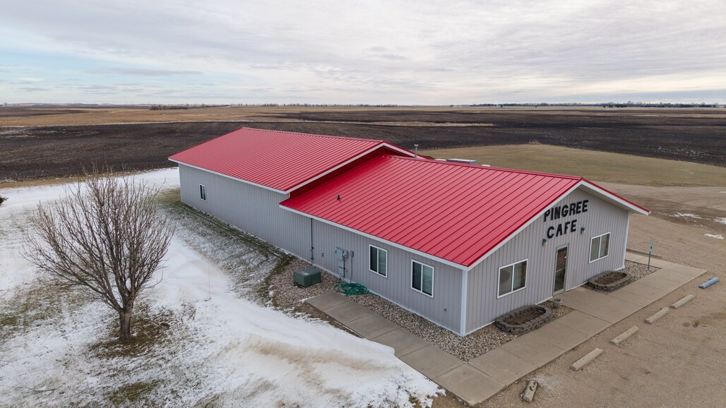 Vetter Construction crew installing standing seam metal roofing
