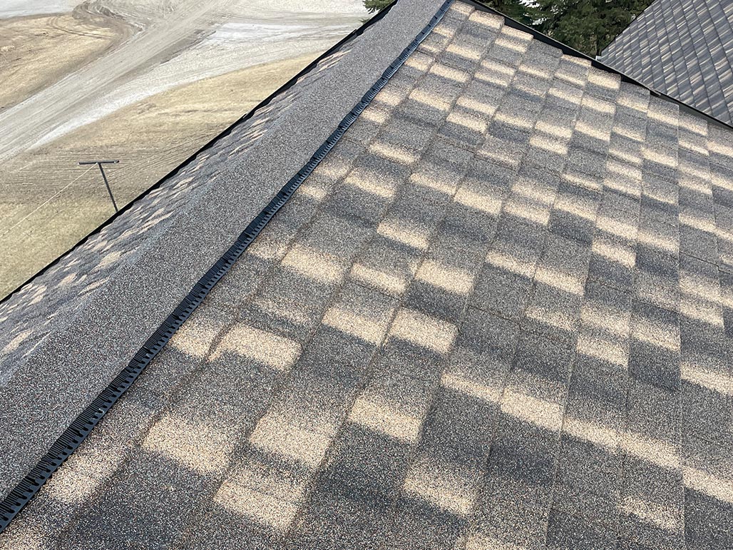 Steel shingle roof installation in progress by Vetter Construction