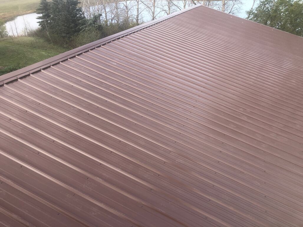 Completed sheet steel roofing installation showing panel detail