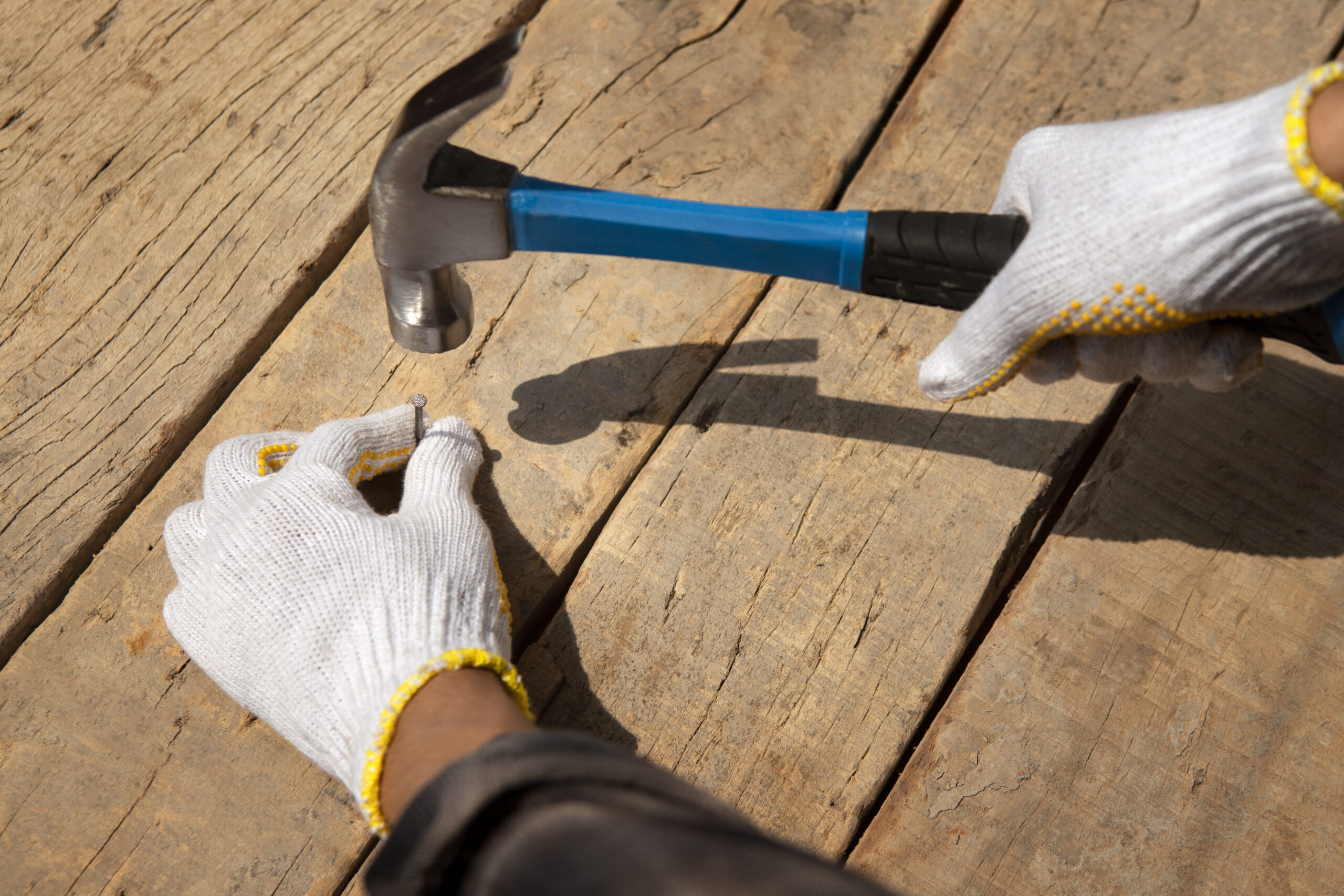 construction-worker-using-hammer-job-site Roof Repairs